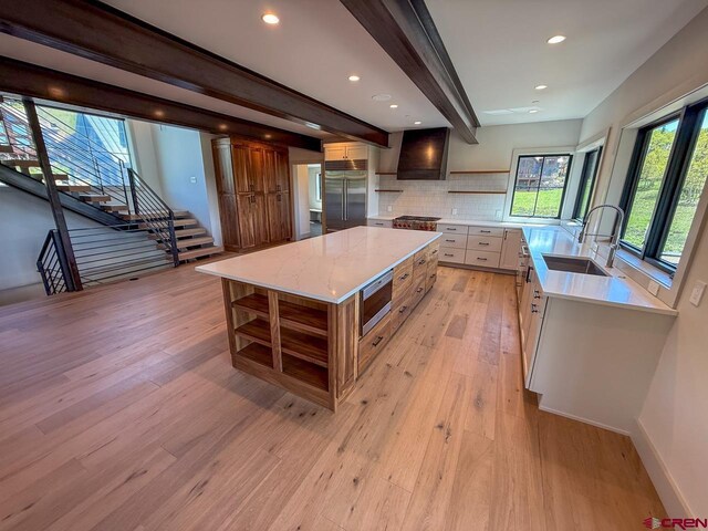 470 Meadow Dr, Crested Butte, CO 81224 - kitchen with a sink, built in appliances, light wood-style floors, a large island, and decorative backsplash