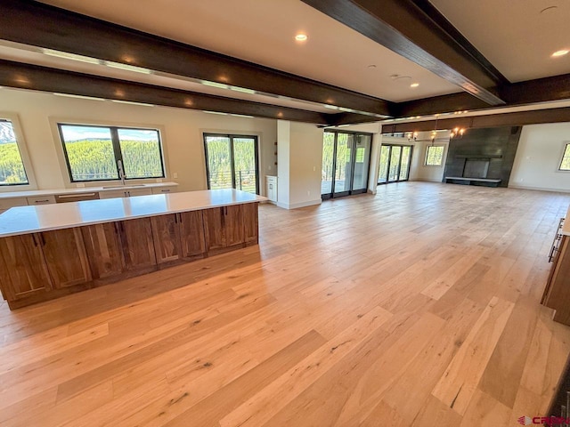 470 Meadow Dr, Crested Butte, CO 81224 - unfurnished living room featuring beam ceiling, light wood finished floors, baseboards, and recessed lighting