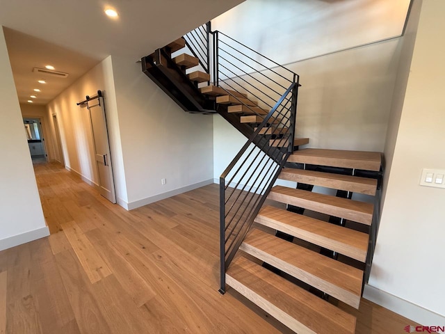 470 Meadow Dr, Crested Butte, CO 81224 - staircase with a barn door, baseboards, wood finished floors, and recessed lighting