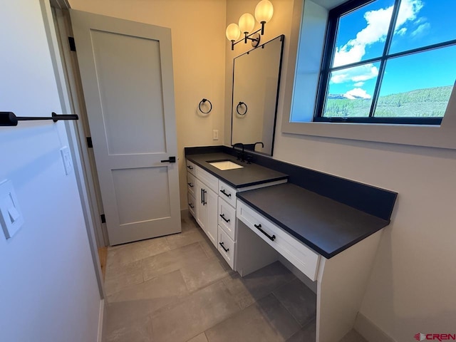 470 Meadow Dr, Crested Butte, CO 81224 - bathroom featuring vanity, a chandelier, baseboards, and tile patterned flooring