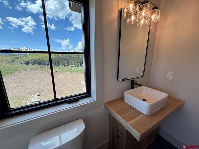 470 Meadow Dr, Crested Butte, CO 81224 - bathroom with a chandelier, plenty of natural light, toilet, and vanity