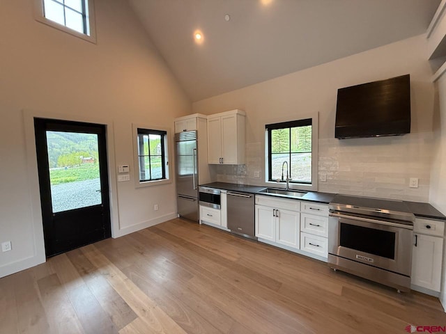 470 Meadow Dr, Crested Butte, CO 81224 - kitchen with appliances with stainless steel finishes, a sink, dark countertops, high vaulted ceiling, and plenty of natural light