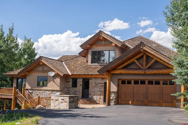 42 Gold Link Dr, Mount Crested Butte, CO 81225 - view of front of home with stone siding, asphalt driveway, stucco siding, and an attached garage
