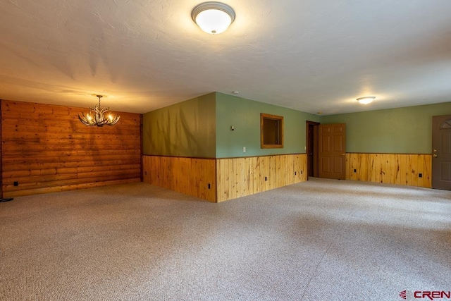 30 Stagecoach Rd, Bayfield, CO 81122 - spare room with wood walls, wainscoting, carpet, and a chandelier