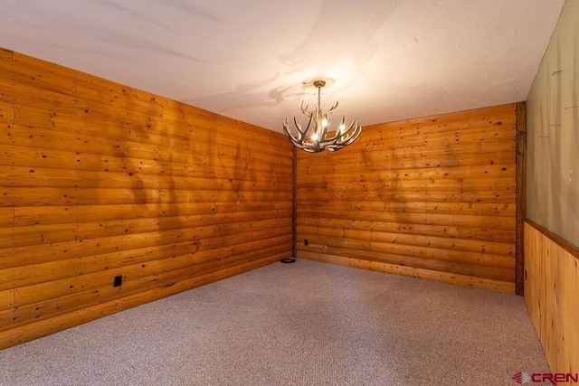 30 Stagecoach Rd, Bayfield, CO 81122 - spare room with a chandelier, wood walls, and light colored carpet