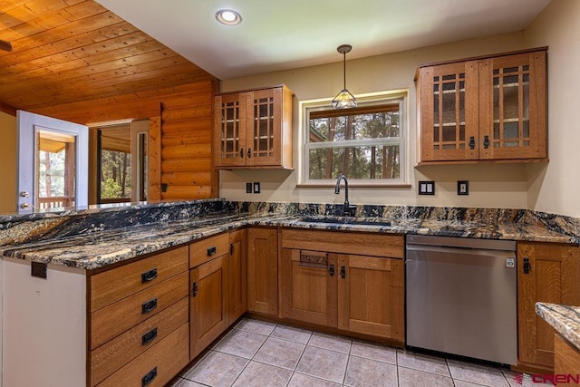 30 Stagecoach Rd, Bayfield, CO 81122 - kitchen with stainless steel dishwasher, a sink, log walls, a peninsula, and brown cabinets