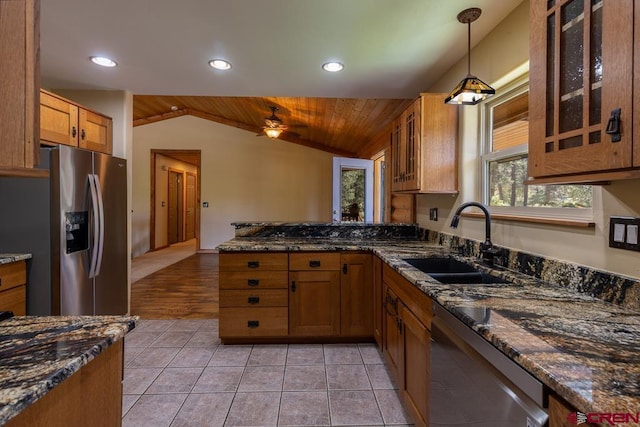 30 Stagecoach Rd, Bayfield, CO 81122 - kitchen featuring appliances with stainless steel finishes, a sink, lofted ceiling, brown cabinetry, and a ceiling fan