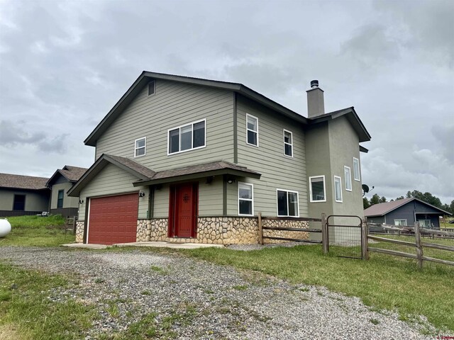 445 Saddle Cir, Pagosa Springs, CO 81147 - view of front of home featuring driveway, a chimney, and stone siding