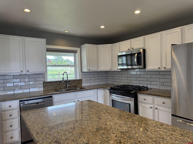 445 Saddle Cir, Pagosa Springs, CO 81147 - kitchen featuring appliances with stainless steel finishes, a sink, recessed lighting, white cabinets, and dark stone counters