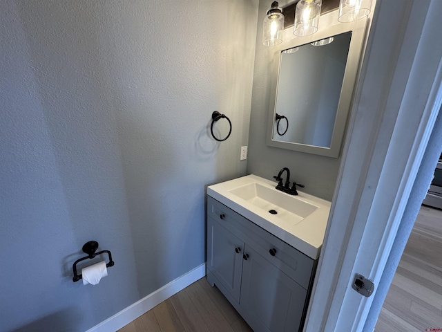 445 Saddle Cir, Pagosa Springs, CO 81147 - bathroom with vanity, wood finished floors, and baseboards