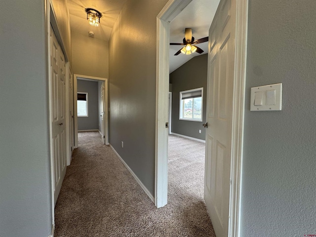 445 Saddle Cir, Pagosa Springs, CO 81147 - hall with carpet, plenty of natural light, vaulted ceiling, a textured wall, and baseboards