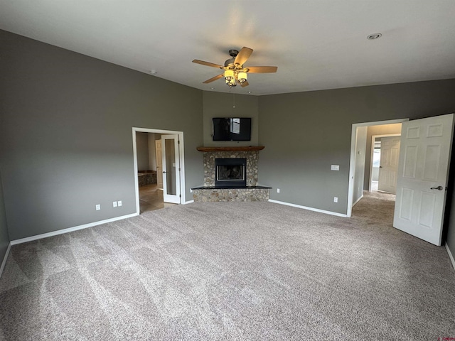 445 Saddle Cir, Pagosa Springs, CO 81147 - unfurnished living room with baseboards, a ceiling fan, carpet flooring, and a fireplace with raised hearth