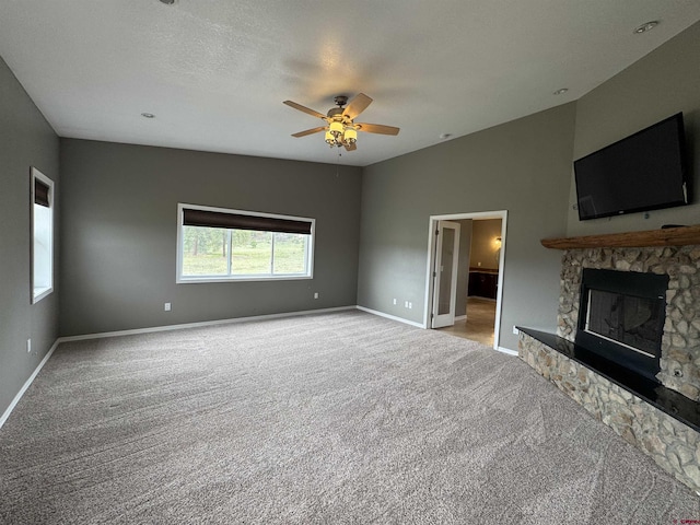 445 Saddle Cir, Pagosa Springs, CO 81147 - unfurnished living room featuring light carpet, a ceiling fan, baseboards, and a fireplace