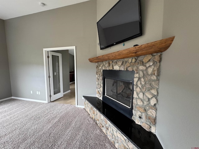 445 Saddle Cir, Pagosa Springs, CO 81147 - unfurnished living room featuring carpet floors, a stone fireplace, and baseboards