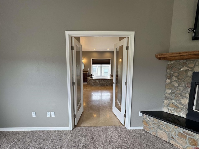 445 Saddle Cir, Pagosa Springs, CO 81147 - corridor featuring baseboards, carpet floors, and tile patterned flooring