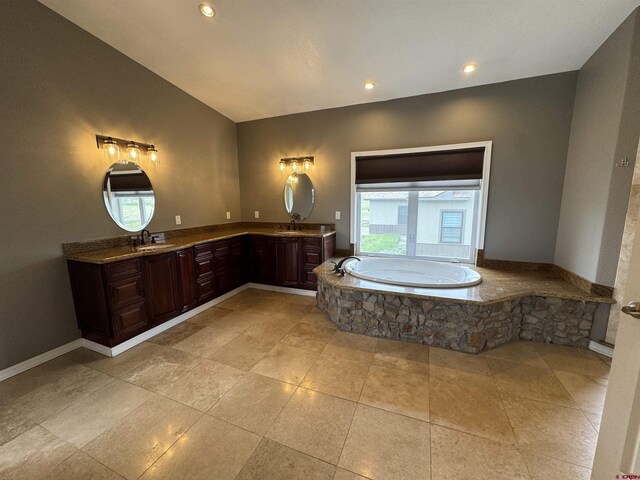 445 Saddle Cir, Pagosa Springs, CO 81147 - full bath featuring double vanity, a bath, vaulted ceiling, recessed lighting, and tile patterned flooring