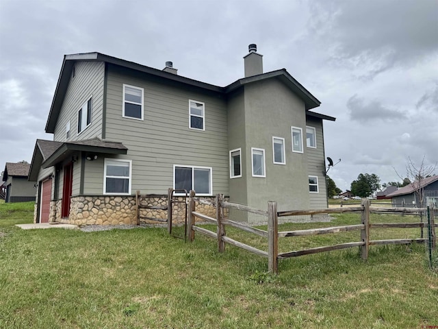 445 Saddle Cir, Pagosa Springs, CO 81147 - rear view of property with a chimney and stone siding