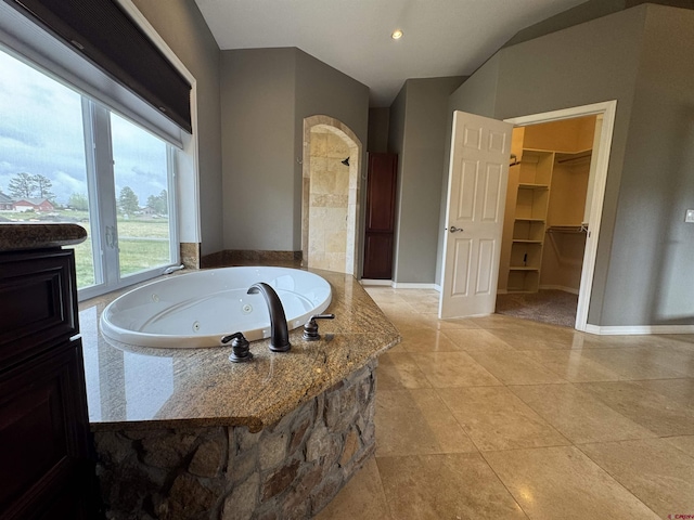 445 Saddle Cir, Pagosa Springs, CO 81147 - full bath featuring a jetted tub, tile patterned floors, baseboards, a walk in closet, and recessed lighting