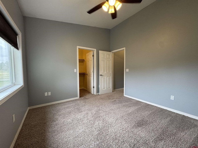 445 Saddle Cir, Pagosa Springs, CO 81147 - unfurnished bedroom featuring carpet, a spacious closet, baseboards, a closet, and vaulted ceiling