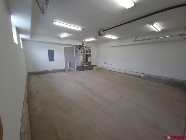 445 Saddle Cir, Pagosa Springs, CO 81147 - garage featuring gas water heater, electric panel, secured water heater, and a garage door opener