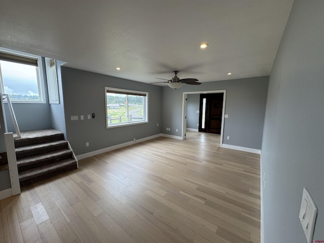 445 Saddle Cir, Pagosa Springs, CO 81147 - unfurnished living room featuring stairway, light wood finished floors, ceiling fan, baseboards, and recessed lighting