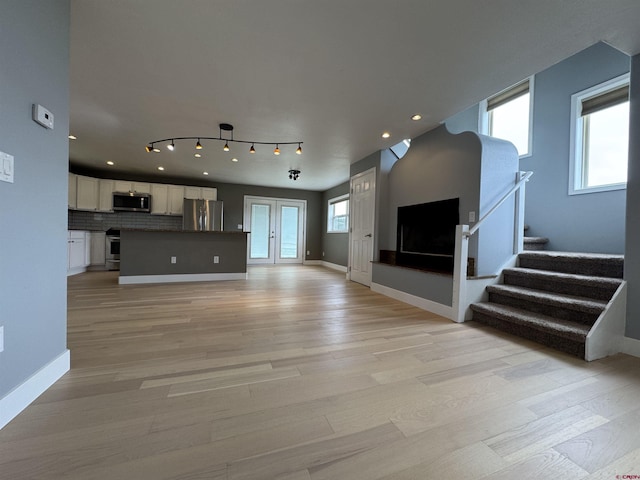 445 Saddle Cir, Pagosa Springs, CO 81147 - unfurnished living room with light wood finished floors, stairs, baseboards, and recessed lighting