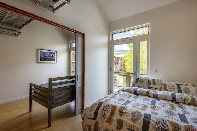 123 Boulders Way, Mountain Village, CO 81435 - bedroom with access to exterior, light wood-type flooring, high vaulted ceiling, and baseboards