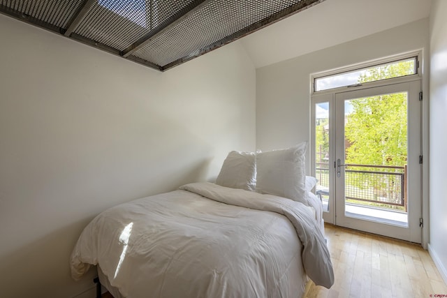 123 Boulders Way, Mountain Village, CO 81435 - bedroom featuring access to outside, multiple windows, light wood-style floors, and lofted ceiling
