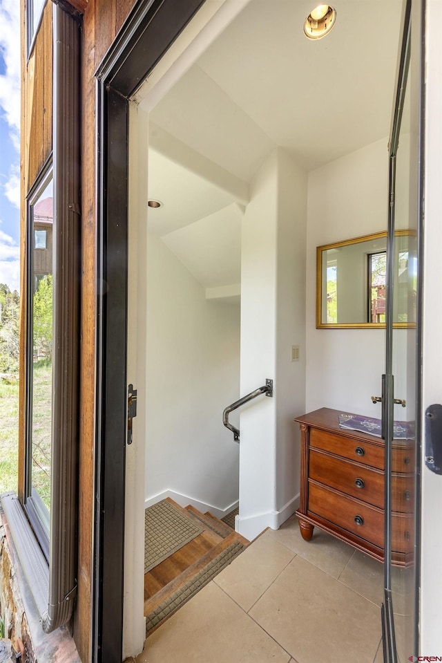 123 Boulders Way, Mountain Village, CO 81435 - corridor featuring light tile patterned floors, baseboards, and stairway