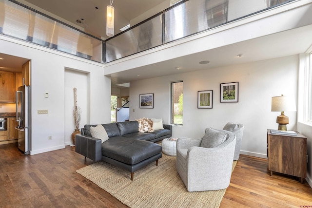 123 Boulders Way, Mountain Village, CO 81435 - living room featuring wood finished floors, baseboards, and a towering ceiling
