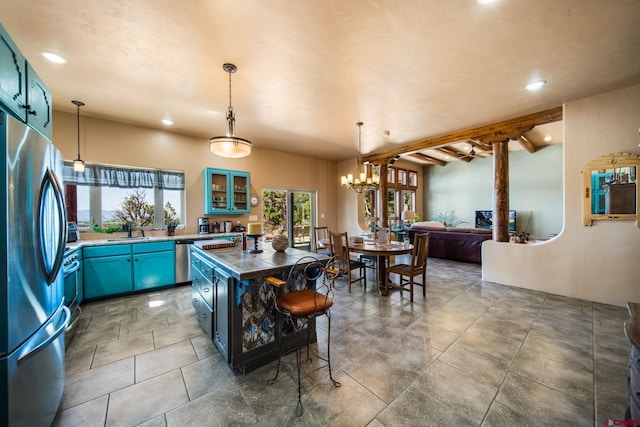 24180 Rd V.4, Dolores, CO 81323 - kitchen with freestanding refrigerator, blue cabinets, recessed lighting, glass insert cabinets, and a sink