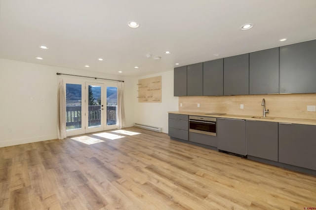 350 Country Club Dr Unit 308A, Crested Butte, CO 81224 - kitchen with gray cabinetry, stainless steel oven, baseboard heating, a sink, and recessed lighting