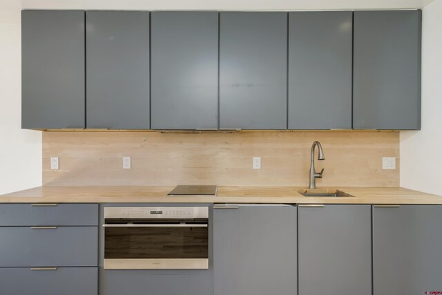 350 Country Club Dr Unit 308A, Crested Butte, CO 81224 - kitchen featuring gray cabinets, oven, modern cabinets, and light countertops