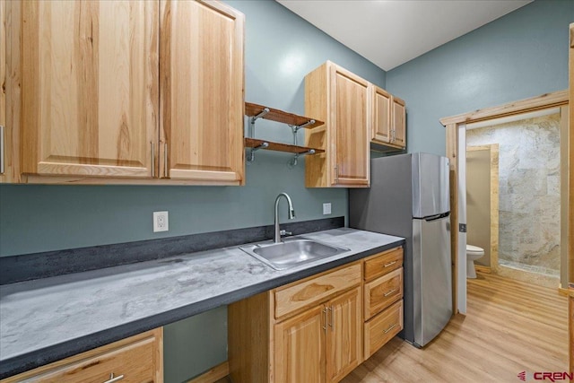 219 7th Ave, Ouray, CO 81427 - kitchen with a sink, freestanding refrigerator, light wood-style flooring, dark countertops, and light brown cabinetry