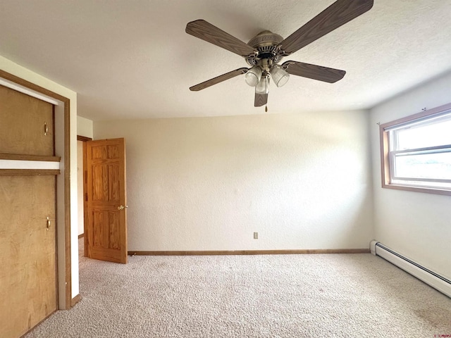 6645 Gaumer Ln, Alamosa, CO 81101 - unfurnished bedroom featuring a baseboard radiator, carpet, baseboards, and ceiling fan