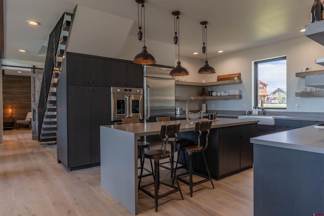 470 White Stallion Cir, Crested Butte, CO 81224 - kitchen featuring open shelves, appliances with stainless steel finishes, a sink, a center island with sink, and recessed lighting
