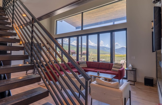 470 White Stallion Cir, Crested Butte, CO 81224 - living area featuring a mountain view, stairway, a towering ceiling, and wood finished floors
