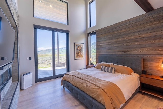 470 White Stallion Cir, Crested Butte, CO 81224 - bedroom with access to outside, wood finished floors, a high ceiling, and a mountain view