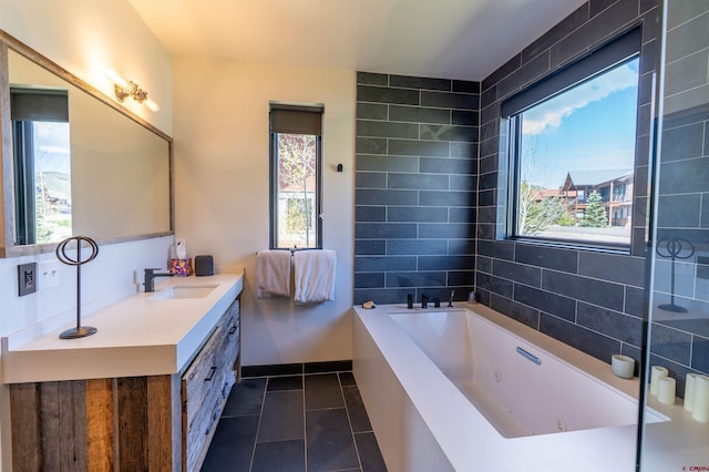 470 White Stallion Cir, Crested Butte, CO 81224 - bathroom featuring a jetted tub, vanity, and tile patterned flooring