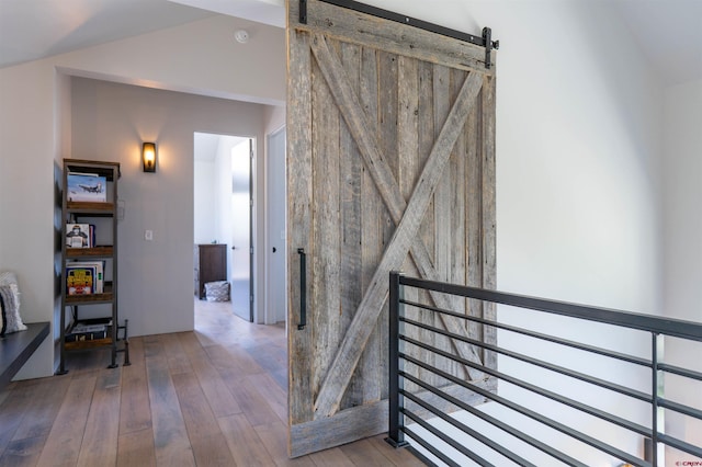 470 White Stallion Cir, Crested Butte, CO 81224 - hallway featuring a barn door and hardwood / wood-style flooring