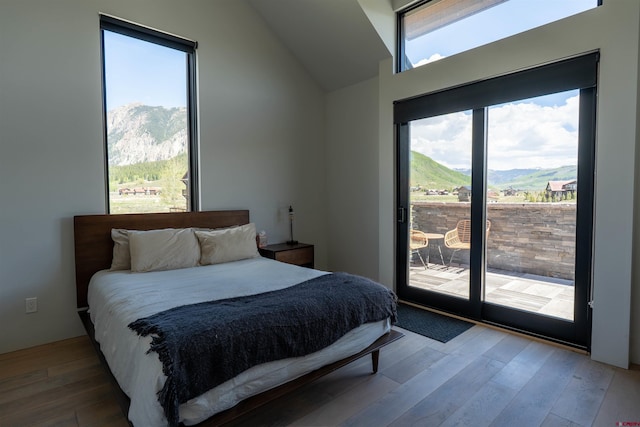 470 White Stallion Cir, Crested Butte, CO 81224 - bedroom featuring access to outside, lofted ceiling, wood finished floors, and a mountain view