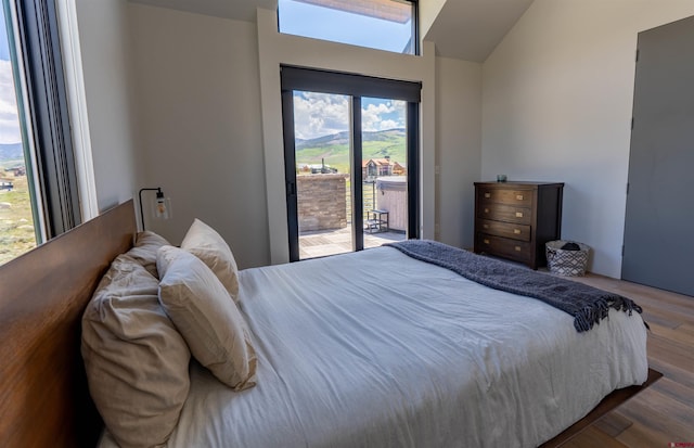 470 White Stallion Cir, Crested Butte, CO 81224 - bedroom with access to outside, vaulted ceiling, and wood finished floors