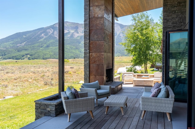 470 White Stallion Cir, Crested Butte, CO 81224 - wooden deck with an outdoor living space and a mountain view