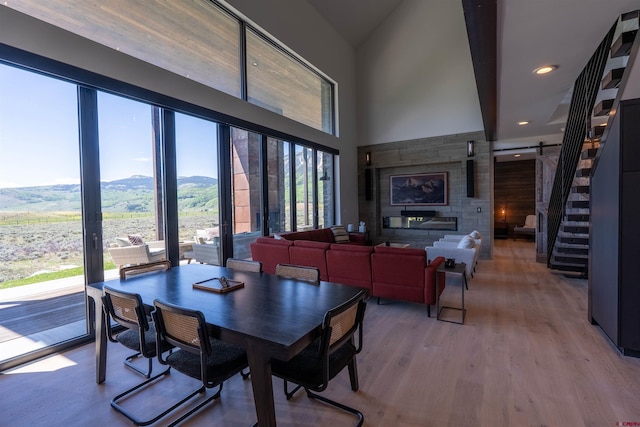 470 White Stallion Cir, Crested Butte, CO 81224 - dining space with healthy amount of natural light, a mountain view, wood finished floors, a high ceiling, and stairs