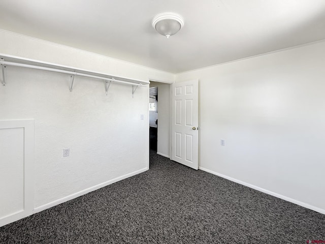 135 N 4th St, Hotchkiss, CO 81419 - unfurnished bedroom with dark carpet and baseboards