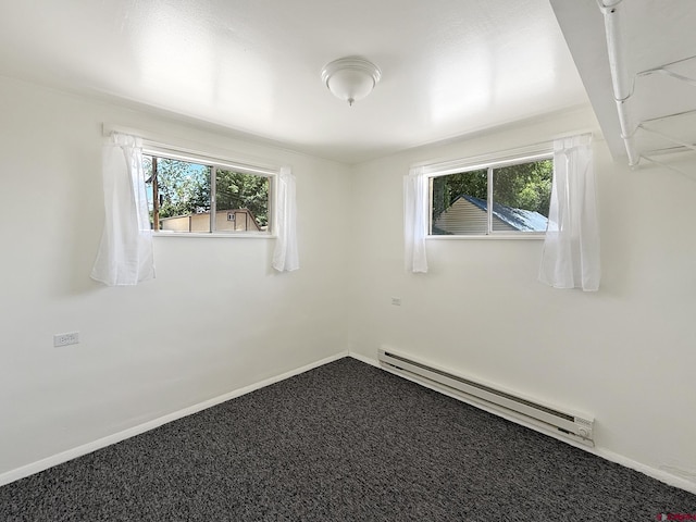 135 N 4th St, Hotchkiss, CO 81419 - carpeted spare room featuring a baseboard radiator, plenty of natural light, and baseboards