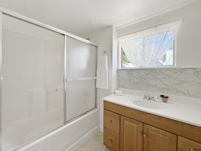 135 N 4th St, Hotchkiss, CO 81419 - bathroom featuring bath / shower combo with glass door, vanity, and tile patterned flooring
