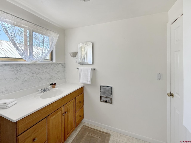 135 N 4th St, Hotchkiss, CO 81419 - bathroom featuring heating unit, vanity, tile patterned floors, baseboards, and decorative backsplash
