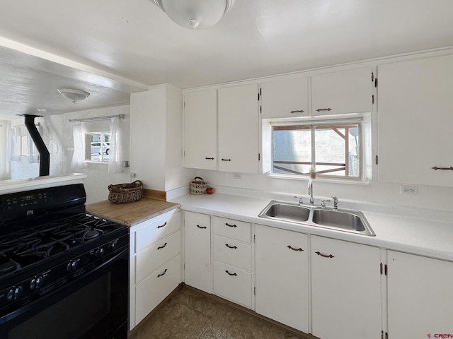 135 N 4th St, Hotchkiss, CO 81419 - kitchen featuring gas stove, a sink, white cabinetry, and light countertops