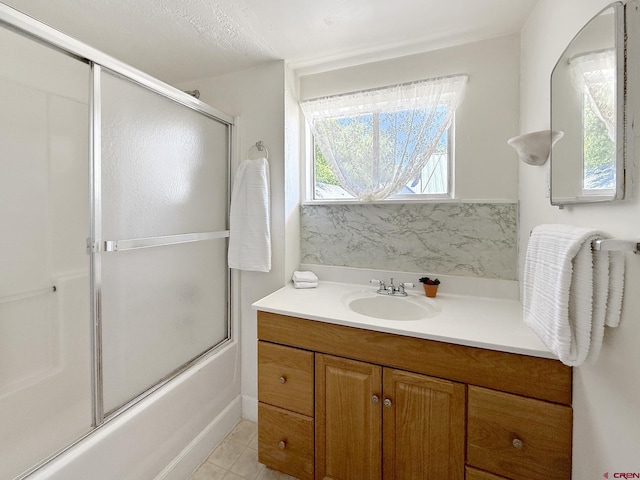 135 N 4th St, Hotchkiss, CO 81419 - bathroom with bath / shower combo with glass door, vanity, and tile patterned floors